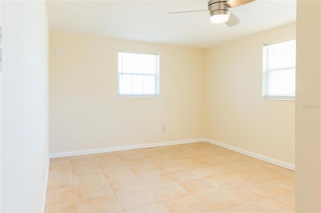 tiled spare room featuring ceiling fan