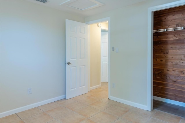 unfurnished bedroom featuring a closet and light tile patterned floors