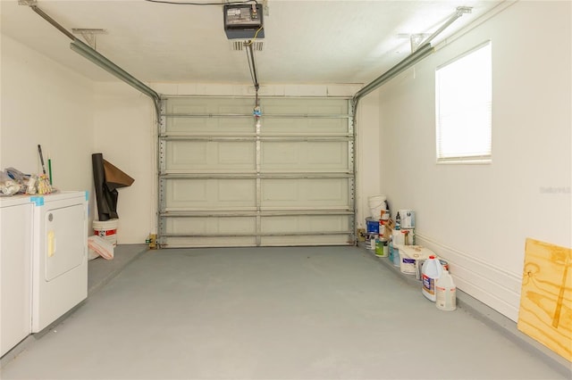 garage with washer and clothes dryer and a garage door opener