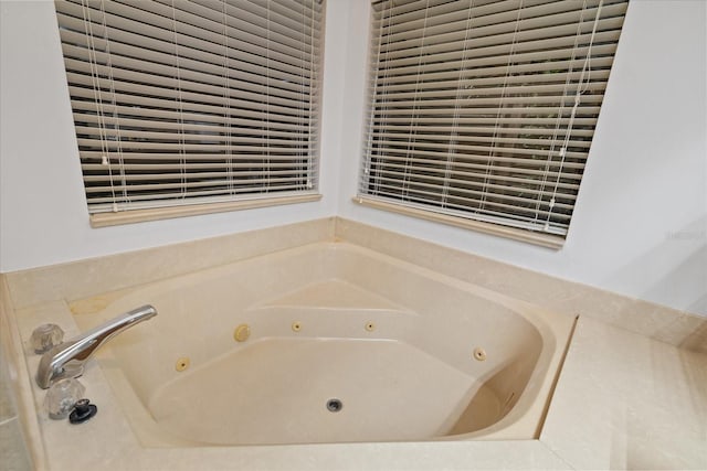 bathroom with a relaxing tiled tub