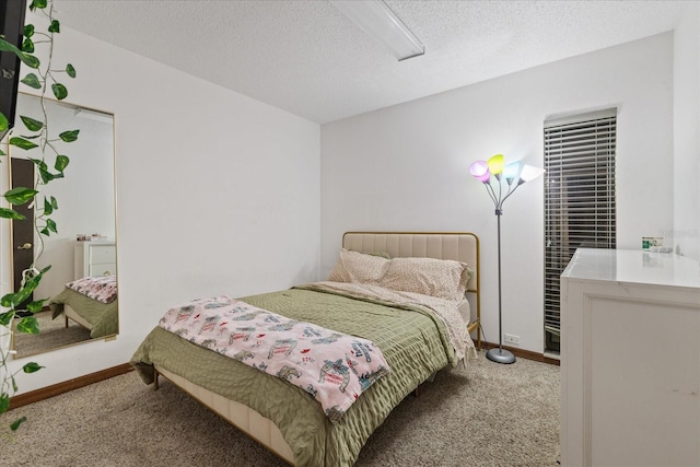 carpeted bedroom featuring a textured ceiling