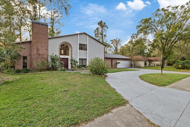 view of front of home featuring a garage and a front yard