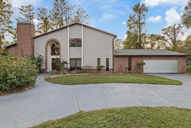 view of front of home with a garage and a front lawn