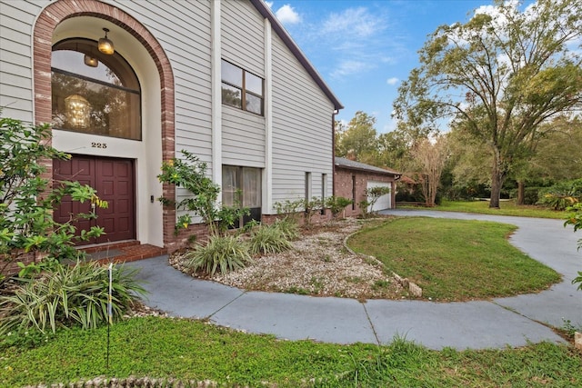 view of property exterior with a garage and a yard