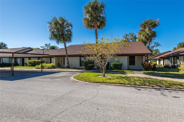 ranch-style home with a front lawn