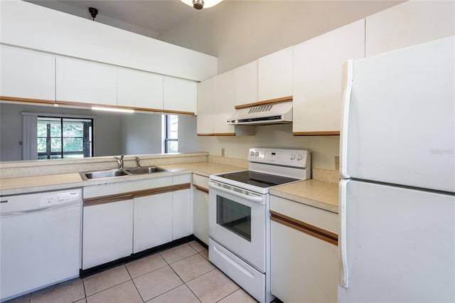 kitchen featuring sink, white appliances, light tile patterned floors, and white cabinets