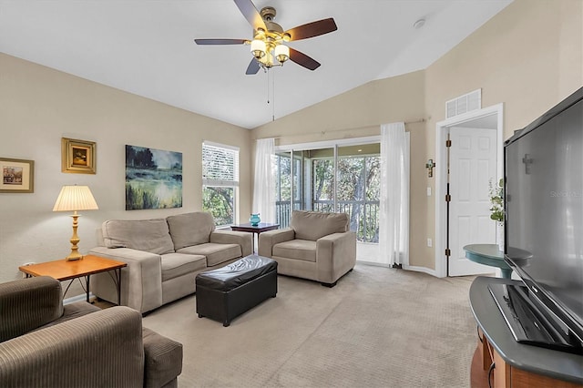 carpeted living room featuring ceiling fan and vaulted ceiling