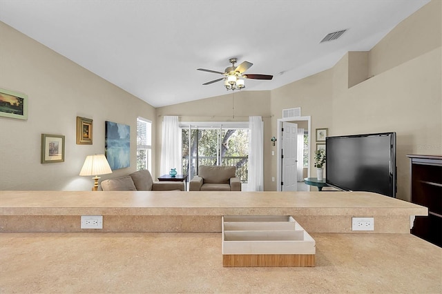 living room with carpet flooring, ceiling fan, and lofted ceiling