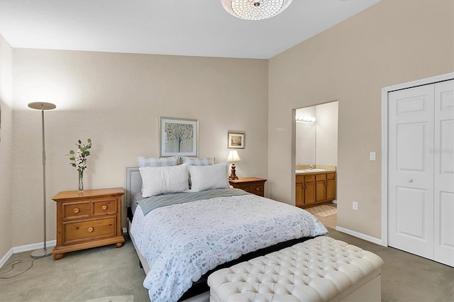 carpeted bedroom with connected bathroom and vaulted ceiling