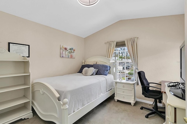 carpeted bedroom with lofted ceiling