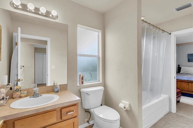 full bathroom featuring tile patterned floors, vanity, shower / tub combo, and toilet