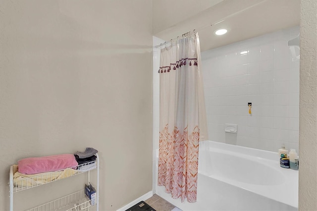 bathroom with tile patterned flooring and shower / bath combo with shower curtain