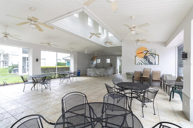 dining room with lofted ceiling and light tile patterned flooring