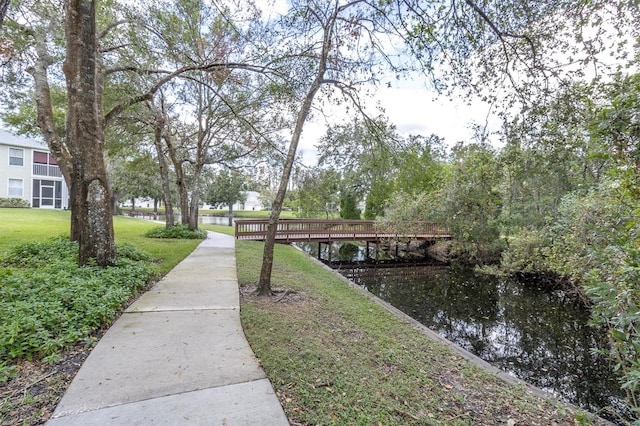 exterior space featuring a water view and a lawn