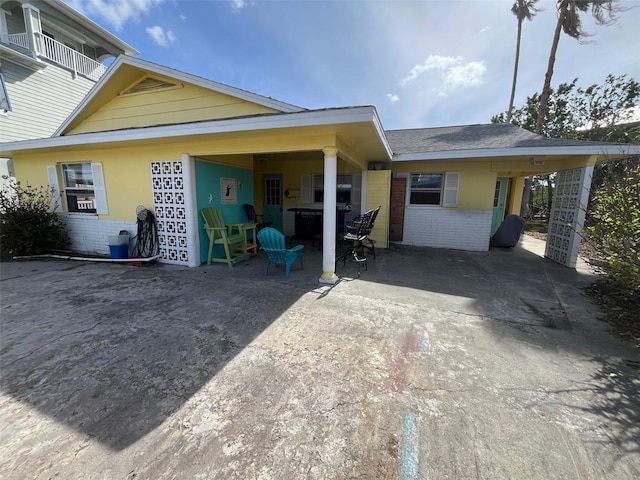 view of property exterior with a balcony and a carport