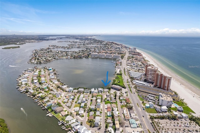 birds eye view of property with a water view and a view of the beach