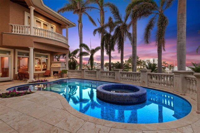101 12th St E, Tierra Verde, FL 33715 - view of pool featuring a patio and a pool with connected hot tub