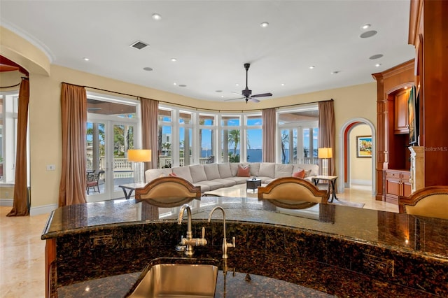 101 12th St E, Tierra Verde, FL 33715 - kitchen featuring a sink, a ceiling fan, dark stone countertops, recessed lighting, and baseboards