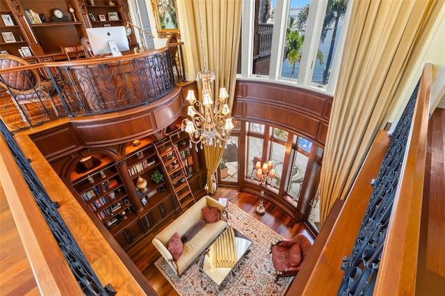 101 12th St E, Tierra Verde, FL 33715 - bar featuring wood finished floors, a chandelier, and a towering ceiling