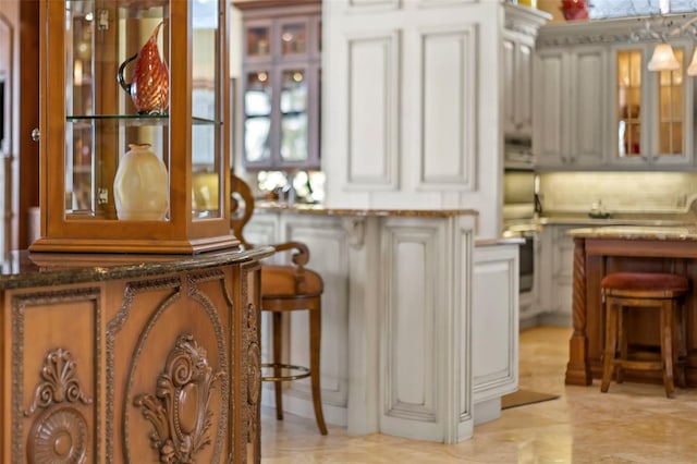 bar with pendant lighting and white cabinetry