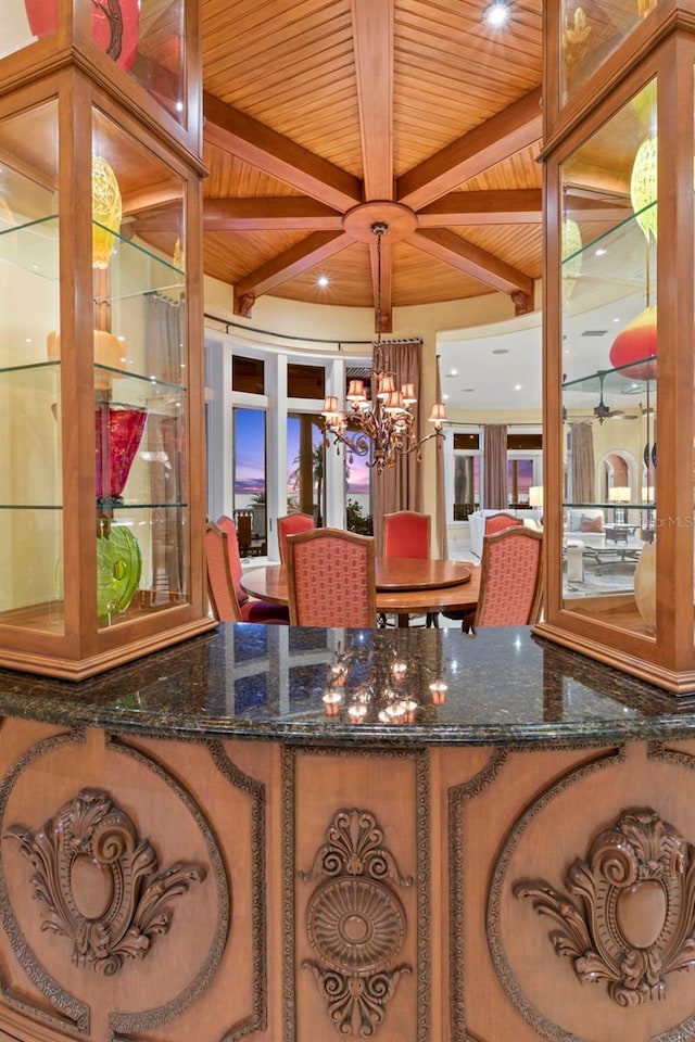 interior space with a chandelier, beamed ceiling, and wood ceiling