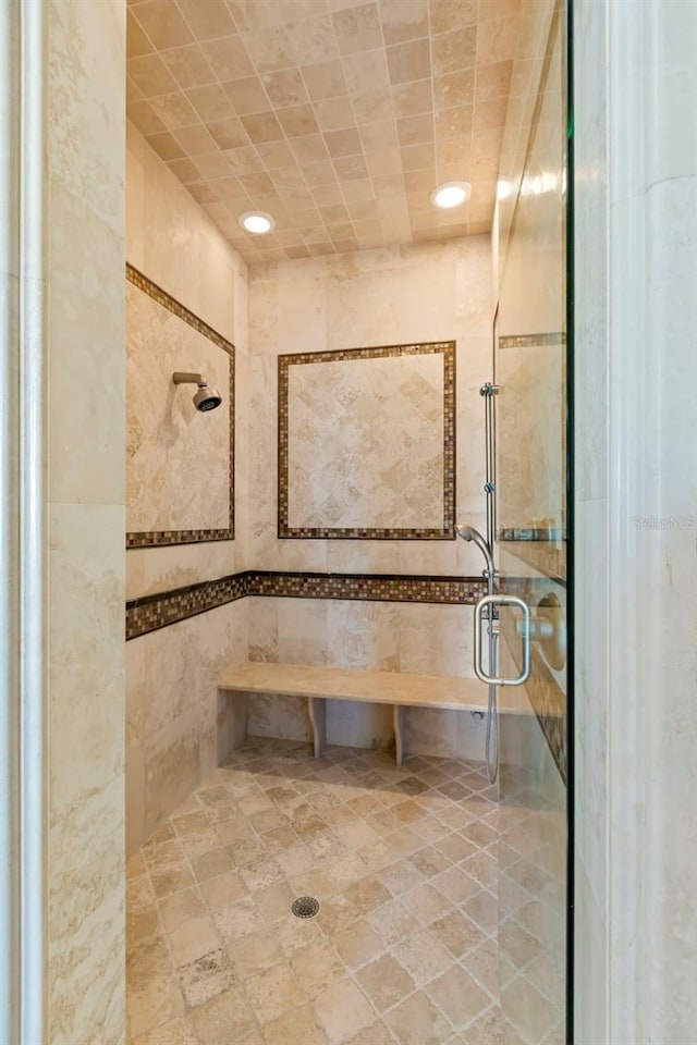 bathroom featuring a shower with door