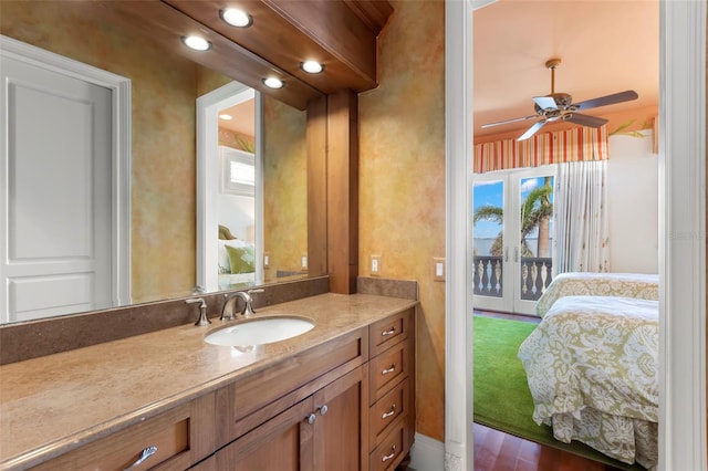 bathroom with hardwood / wood-style flooring, ceiling fan, and vanity