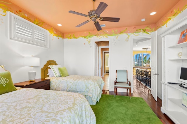 bedroom with ceiling fan and dark hardwood / wood-style flooring