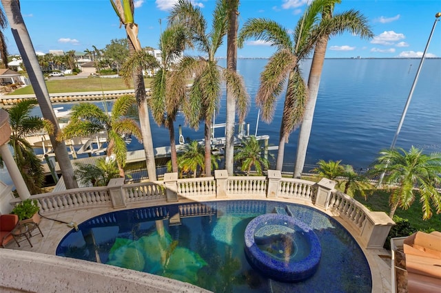 101 12th St E, Tierra Verde, FL 33715 - view of swimming pool with a water view and a pool with connected hot tub