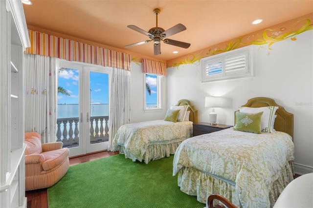 101 12th St E, Tierra Verde, FL 33715 - bedroom featuring access to exterior, wood finished floors, recessed lighting, ceiling fan, and a water view