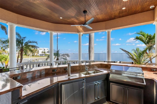 101 12th St E, Tierra Verde, FL 33715 - view of patio with a sink, a water view, and a ceiling fan