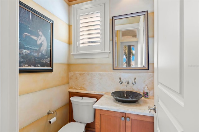 101 12th St E, Tierra Verde, FL 33715 - half bathroom with toilet, vanity, and backsplash