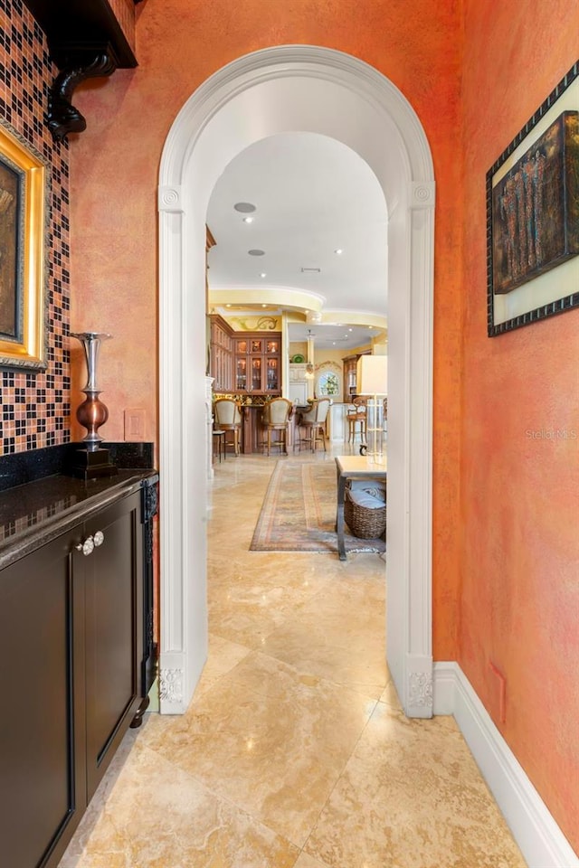 101 12th St E, Tierra Verde, FL 33715 - hallway with arched walkways and baseboards