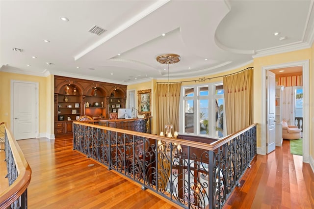 corridor featuring hardwood / wood-style floors and crown molding