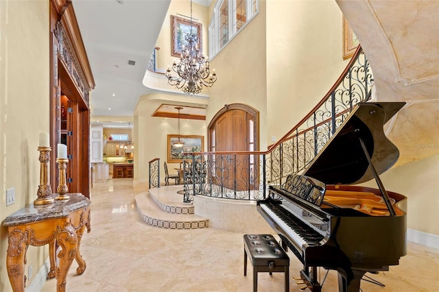 entrance foyer with a towering ceiling and an inviting chandelier