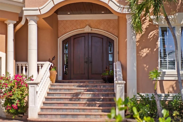 101 12th St E, Tierra Verde, FL 33715 - property entrance with covered porch and stucco siding