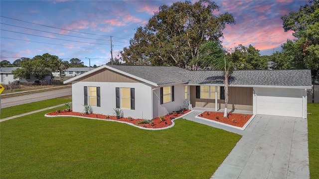 ranch-style home with a lawn and a garage