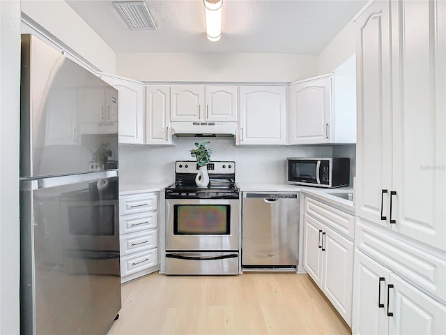 kitchen featuring white cabinets, stainless steel appliances, and light hardwood / wood-style flooring