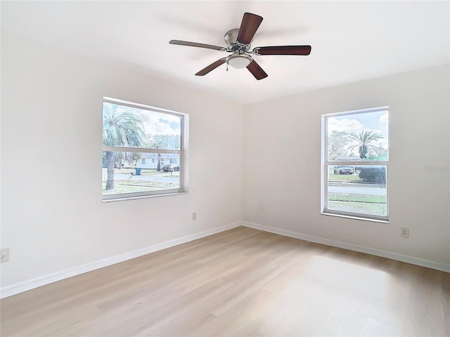 unfurnished room with ceiling fan, a healthy amount of sunlight, and light wood-type flooring