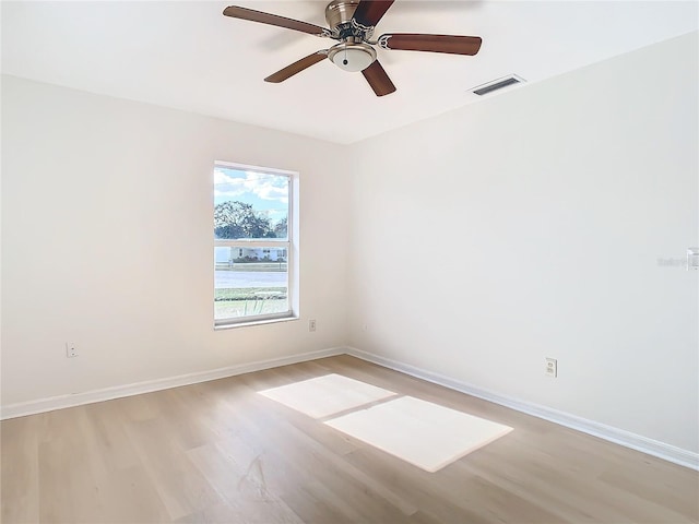 spare room with light hardwood / wood-style floors and ceiling fan