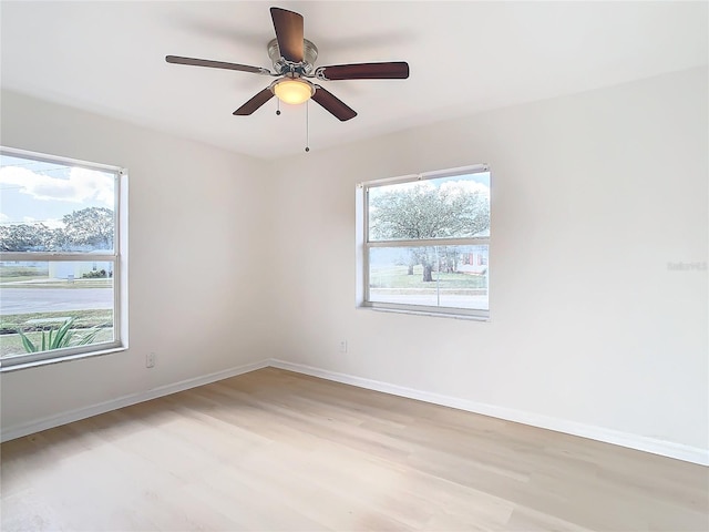 unfurnished room featuring light wood-type flooring and ceiling fan