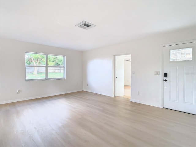 empty room with light hardwood / wood-style floors