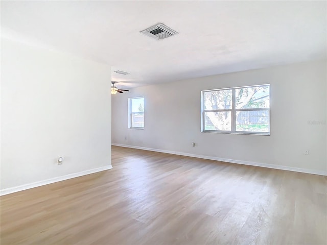 empty room featuring light hardwood / wood-style floors, plenty of natural light, and ceiling fan