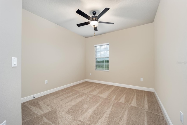 carpeted empty room with ceiling fan