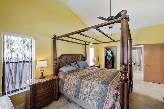 tiled bedroom with lofted ceiling, ceiling fan, a spacious closet, and a closet