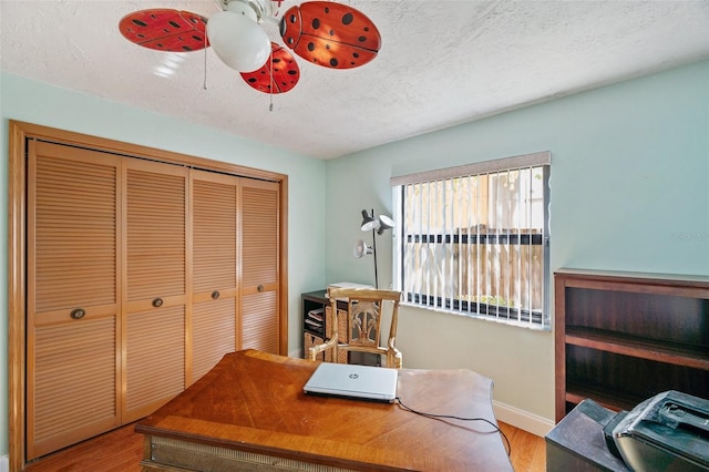 office with ceiling fan, a textured ceiling, and light hardwood / wood-style flooring