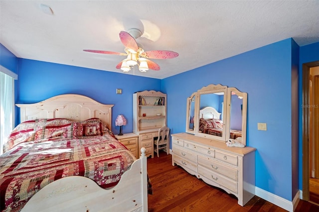 bedroom featuring ceiling fan, dark hardwood / wood-style flooring, and a textured ceiling