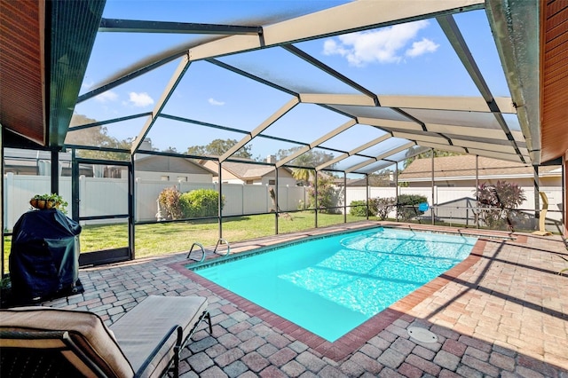 view of pool featuring area for grilling, a lanai, a yard, and a patio