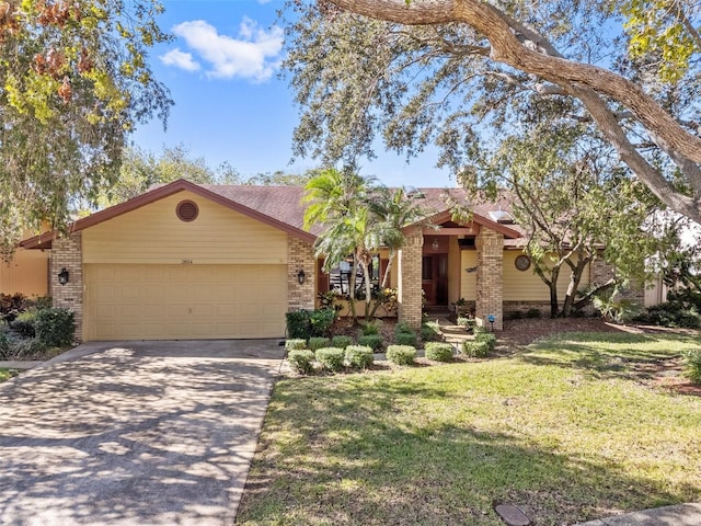 ranch-style house featuring a garage and a front yard