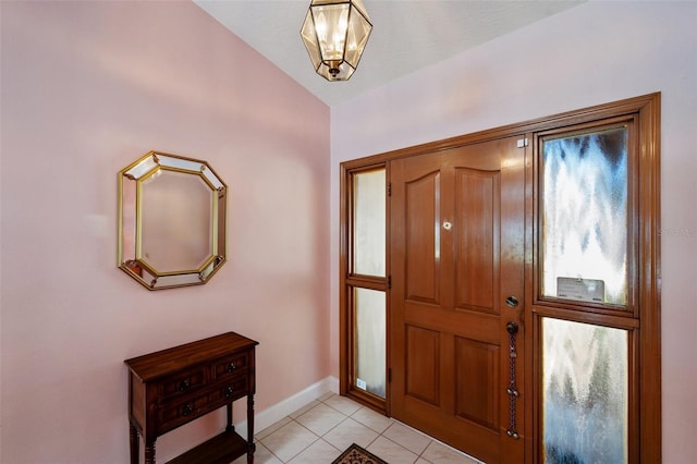 entrance foyer featuring light tile patterned floors and vaulted ceiling